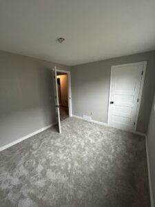 A newly renovated room with fresh carpet and paint, completed by Dakota Small Jobs handyman services in Sioux Falls, SD.