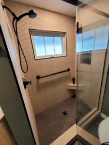 A newly renovated shower with modern fixtures and tiling, completed by Renew Additions & Remodeling, LLC in Columbus, OH.