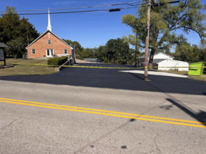 A newly sealcoated asphalt parking lot in front of a church by Gorman sealcoating & striping in Blue Springs, MO.