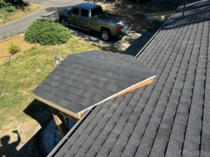 A newly shingled roof section over a custom entryway structure by JJT Construction in Portland, OR.