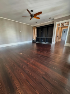 Newly stained dark hardwood floor and ceiling fan by Trades by Taylor LLC in Huntsville, AL.