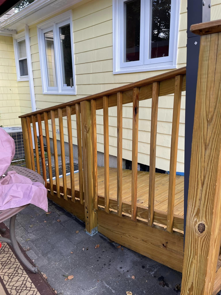 A newly stained wooden deck and railing completed by Digby Handyman Services LLC in Cranston, RI.
