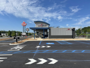 A newly striped parking lot with blue and white markings for 7 Brew Coffee by Marine One Striping in Clarksville, TN.