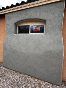 A newly stuccoed wall with a clean window installation by Old Pueblo Stucco, Inc. in Tucson, AZ