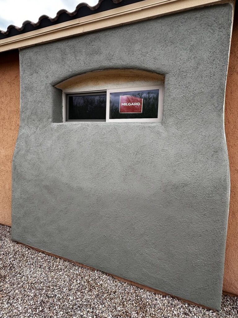 A newly stuccoed wall with a clean window installation by Old Pueblo Stucco, Inc. in Tucson, AZ