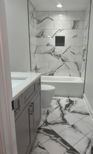 A newly renovated bathroom featuring marble-look tile installation by A&L Tile LLC in San Diego, CA