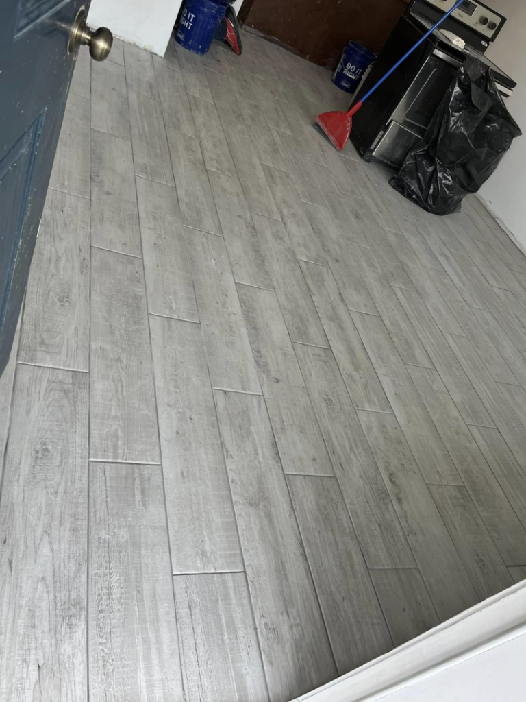 A newly installed tiled floor in a kitchen area, completed by Worths handyman services in Wasilla, AK.