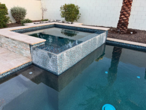 A beautifully tiled spa and swimming pool area, showcasing work by Mr. Pools LLC in Gilbert, AZ.