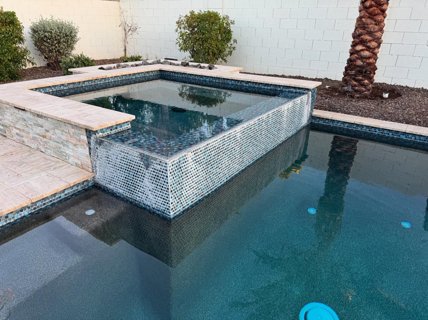 A beautifully tiled spa and swimming pool area, showcasing work by Mr. Pools LLC in Gilbert, AZ.