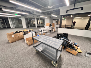 An office space with furniture, boxes, and cables awaiting removal by Republic Junk Removal in San Diego, CA.