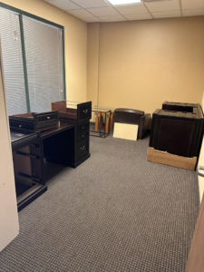 Office furniture including desks and cabinets ready for cleanout and removal by HD Junk Removal in Gilbert, AZ