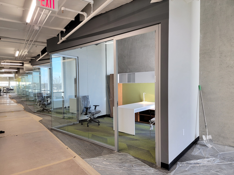 An office interior undergoing renovation with glass partitions and new furniture by Vanston/O'Brien, Inc. in Ann Arbor, MI