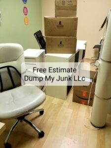 An office space with boxes and furniture ready for junk removal by Dump My Junk LLC Demolition & Dumpster Rental in Tampa, FL.