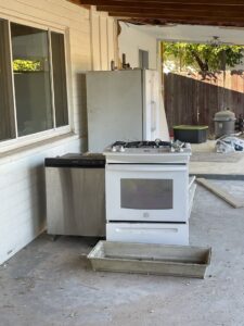 Old appliances including a refrigerator and stove ready for removal by Canyon State Junk Removal in Peoria, AZ