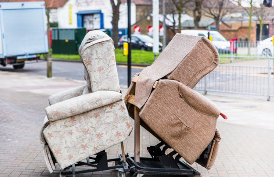 Two old armchairs on dollies ready for pickup by Junk Removal Services GA in Gainesville, GA
