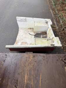 An old, broken boat hull ready for removal by Won't Bash Your Trash in Savannah, GA.