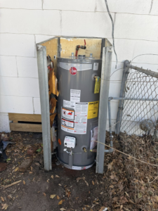 An old and damaged outdoor water heater, indicating a need for repair or replacement by High Tide Home Remodeling in Charleston, SC.