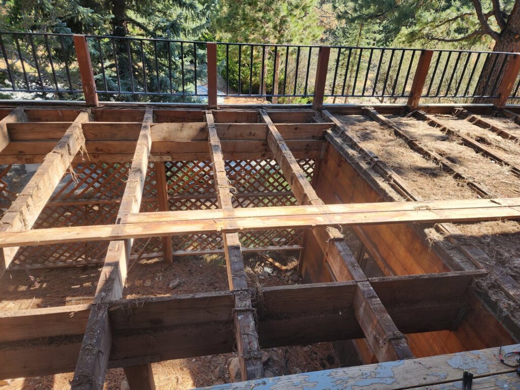Old deck framing visible during a demolition or repair project, showcasing deck services by Tillman's Handyman Service in Sparks, NV.