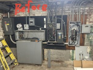 An old and disorganized electrical panel system before an upgrade by Vakulskas Electric in Sioux City, IA.