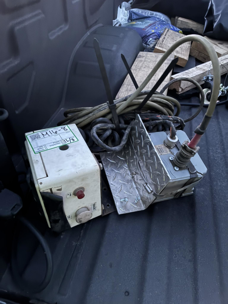 Old equipment parts and wooden pallets in a truck bed for junk removal by Tracer Transport LLC in Fort Wayne, IN.