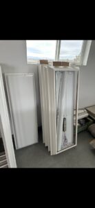 Old fluorescent light fixtures and panels piled up for junk removal by Haul My Load LLC in Caldwell, ID.