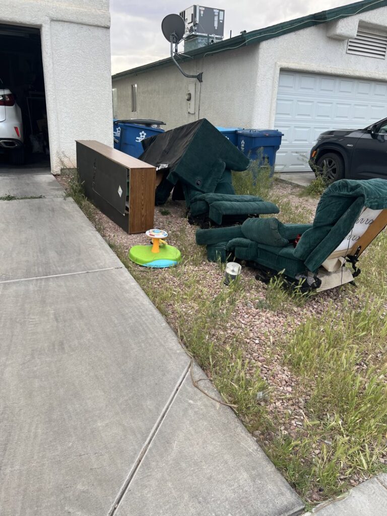 Old furniture and bulky items piled outside a home, awaiting junk removal by MGM Household Services in Las Vegas, NV.