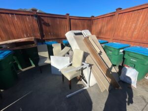 Old furniture and wood planks piled up for junk removal by Veterans Easy Trash: Atlanta in Atlanta, GA.