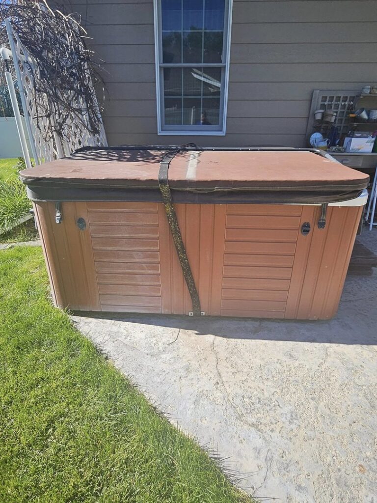 An old hot tub in a backyard, ready for removal by Big Sky Junk Removal LLC in Billings, MT.