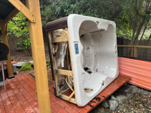An old hot tub being removed from a backyard by Junk Guys Sacramento in Roseville, CA.