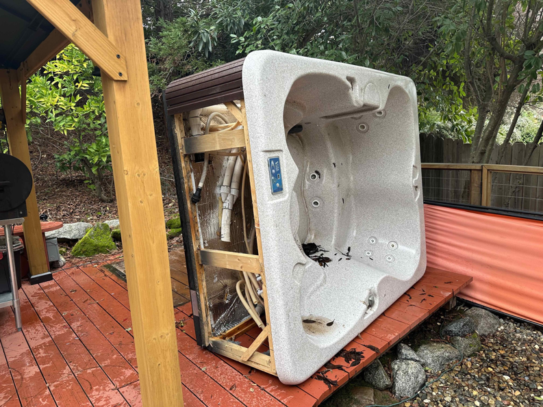 An old hot tub being removed from a backyard by Junk Guys Sacramento in Roseville, CA.