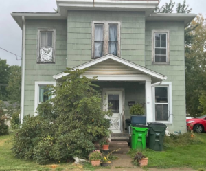 An old house exterior before renovation, showing the potential for transformation by 1st Choice Windows in Canton, OH.