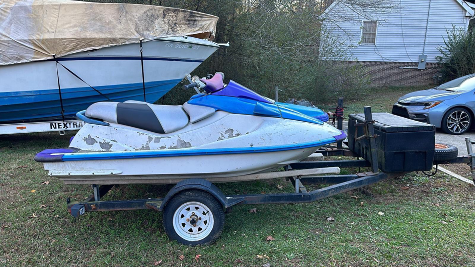An old, worn jet ski on a trailer, ready for removal by Federal Junk Removal in Los Angeles, CA.