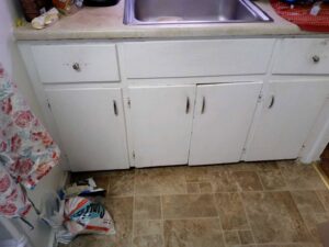 Old kitchen cabinets and sink before renovation by Vermont Professional Solutions LLC in South Burlington, VT.