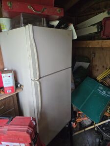 An old refrigerator and various items cluttering a shed, awaiting junk removal by CC JUNK Removal in Corpus Christi, TX.