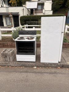 An old white refrigerator and stove ready for removal by HB Junk Hauling LLC in Springfield, OR.