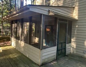 An old screened porch showing its condition before renovation, a project for X-Terior Techs in Henrico, VA.