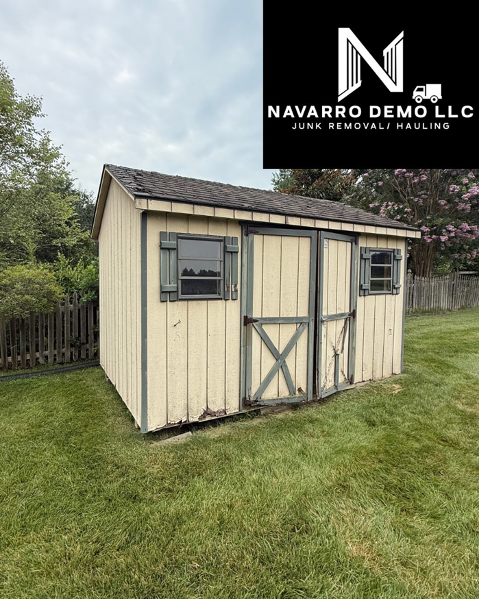 An old wooden shed in a backyard before demolition by Navarro Demo LLC in Rockville, MD