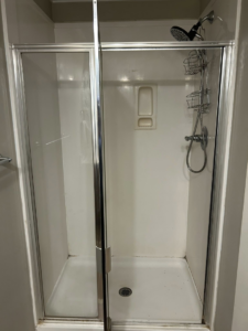 An old, outdated shower stall before renovation, a service offered by Ingram Painting and Renovation in Birmingham, AL.