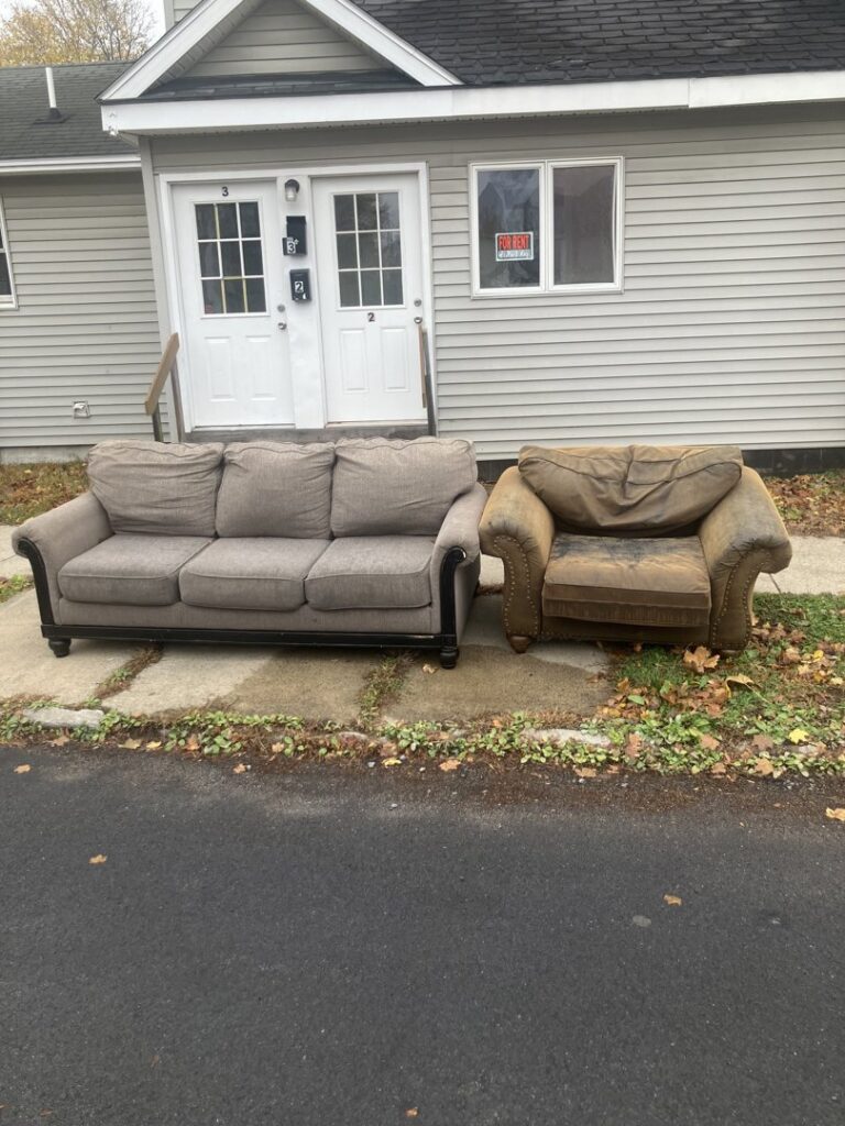 An old sofa and armchair placed on the curb, awaiting pickup for junk removal by Clutter Bandit in Albany, NY.