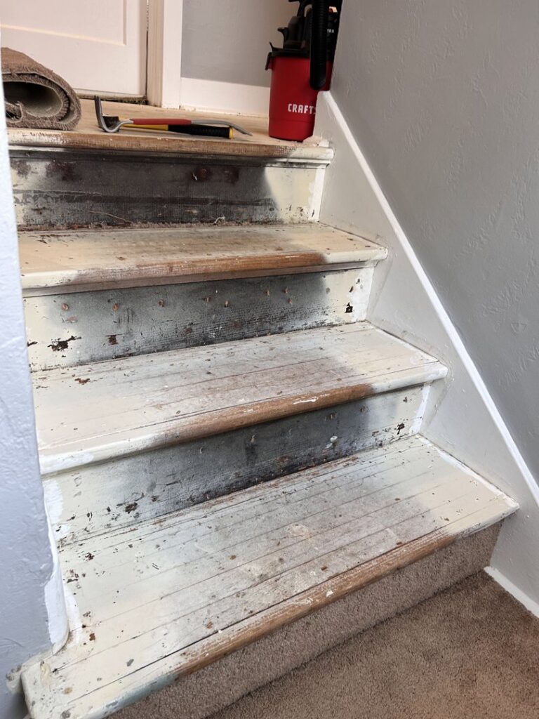 Old, painted stairs with peeling paint, awaiting renovation or refinishing by NV Floors LLC in Pittsburgh, PA.