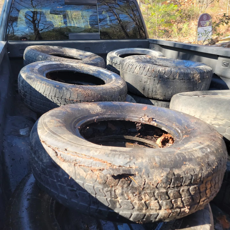 A pickup truck bed filled with old, dirty tires for removal by Haulin' Junk Chattanooga in Chattanooga, TN.