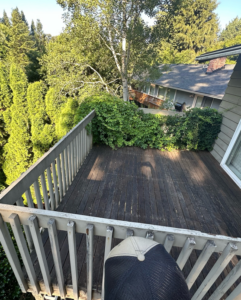 An old, weathered wooden deck with worn railings and overgrown ivy, ready for renovation by Rosas Construction and Renovation in Dallas, TX.