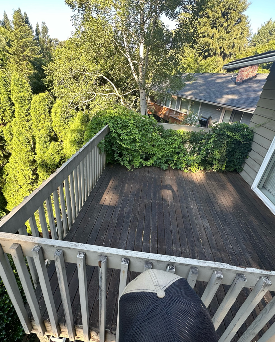 An old, weathered wooden deck with worn railings and overgrown ivy, ready for renovation by Rosas Construction and Renovation in Dallas, TX.