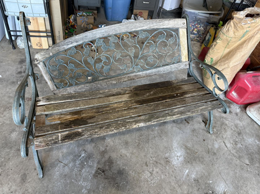 An old, weathered outdoor bench with wooden slats needing repair, a project for Bill's Handyman Services in Anchorage, AK.
