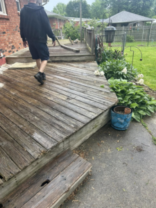 An old, weathered wooden deck showing signs of wear, ready for repair or maintenance by A2 Construction in Louisville, KY.