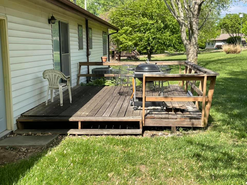 An old, weathered wooden deck before renovation by Capital T's Home Specialty LLC in Topeka, KS.