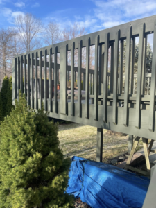 An old wooden deck with railings, showing a renovation project by Horstman Construction in Erie, PA.