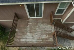 An old, worn wooden deck with peeling finish, indicating a need for repair or replacement services from Ridgeline Decks in Spokane, WA.
