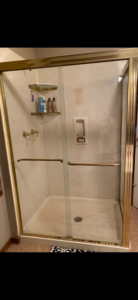 Older gold-frame shower enclosure installation by Thermal Concepts, Inc in St. Louis, MO.