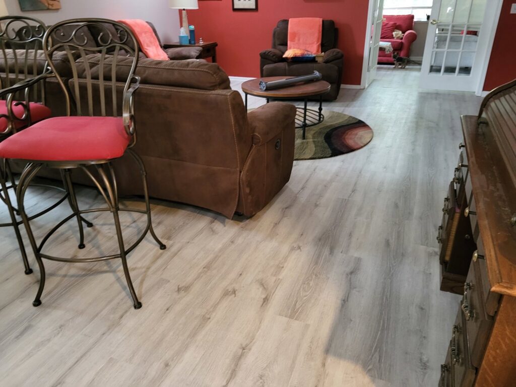 Open living area with new LVP flooring installed by Gladiator Flooring LLC, a handyman service in Summerville, SC.